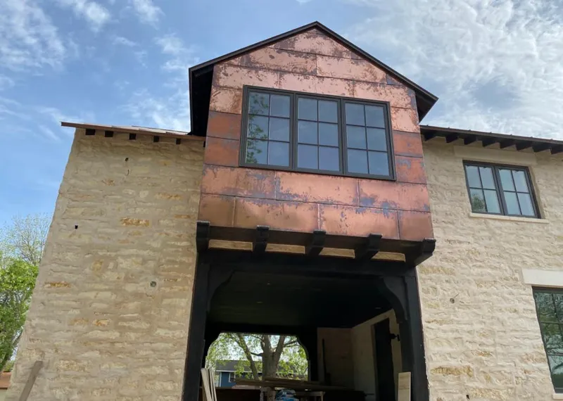 Copper metal panel facade on a stone building for Skylight Installation in Omaha