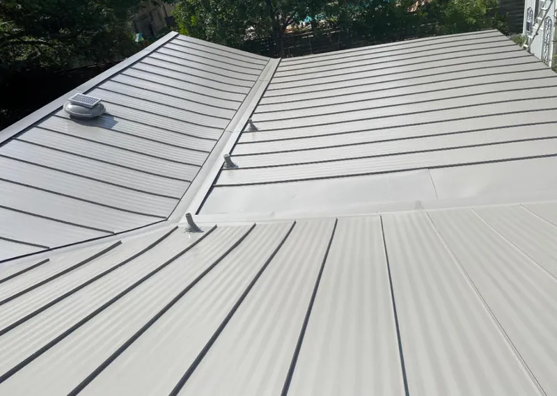 Solar attic fan installed on a metal roof for Roof Ventilation in Omaha